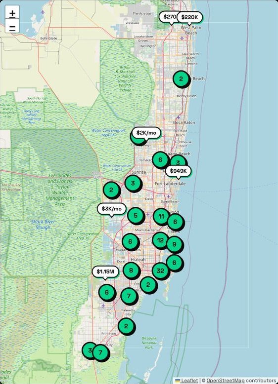 The map side of the search page on the live demo: price pins and clusters over South Florida, with zoom controls. Map data from OpenStreetMap contributors, via Leaflet.